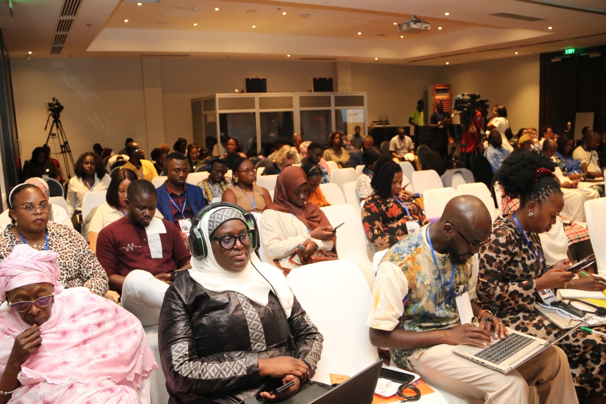 Participants with interpretation headsets during the panel at the NGOs Forum